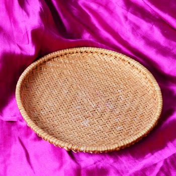 empty basket on the pink satin