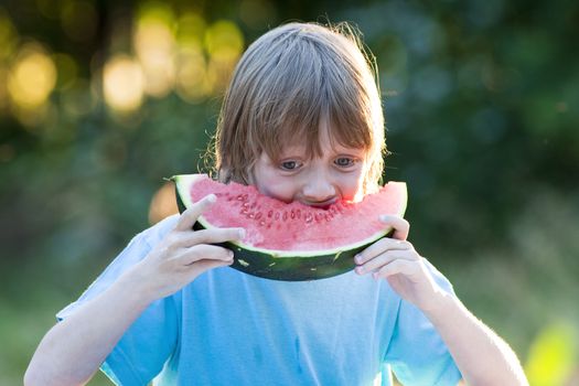Boy Eating Watermelon Outdoors