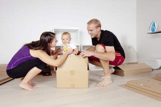 Young Family with a Baby Moving in a New Apartment