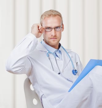 Portrait of a Young Doctor with Stethoscope and Glasses Looking