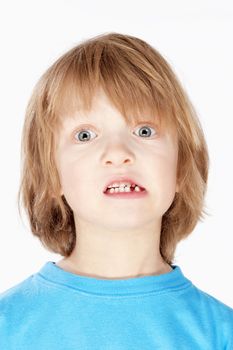 Boy with Blond Hair Showing his Missing Milk Teeth - Isolated on White