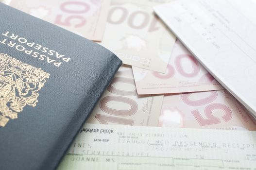 Coquitlam, BC, Canada - July 24, 2014 : Canada passport with boarding pass and money on the table.  All Canadian passports are issued by Passport Canada. 