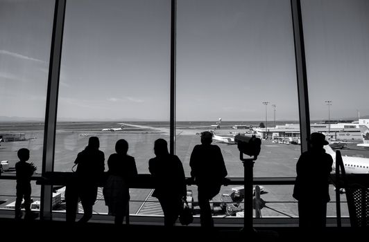 Vancouver, BC Canada - September 13, 2014 : People inside YVR airport watching air canada airplane in Vancouver BC Canada. 