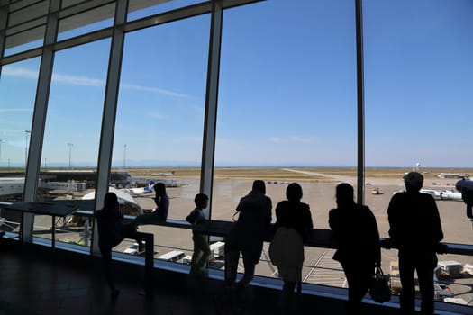 Vancouver, BC Canada - September 13,  2014 : People inside YVR airport watching air canada airplane in Vancouver BC Canada. 