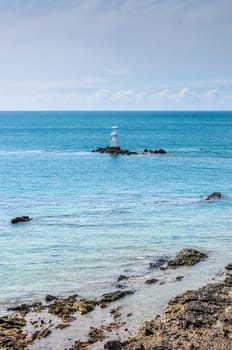 White Lighthouse on the sea and blue sky in Thailand