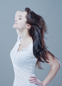 portrait of a teenage girl with brown hair against gray background