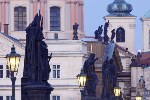 prague - religious art on charles bridge, lanterns and spires of the old town