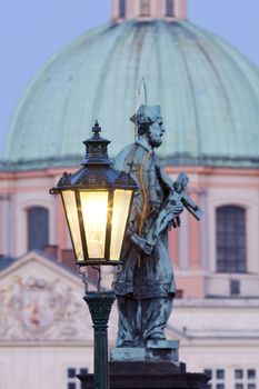 prague - religious art on charles bridge, lanterns and spires of the old town