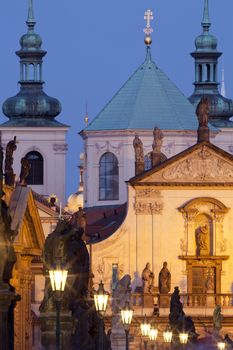 prague - religious art on charles bridge, lanterns and spires of the old town