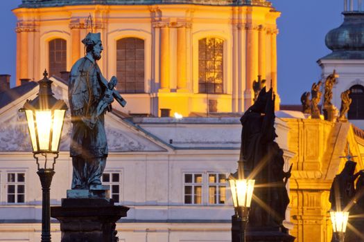 prague - religious art on charles bridge, lanterns and spires of the old town