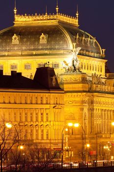 prague - illuminated national theater and city traffic at night