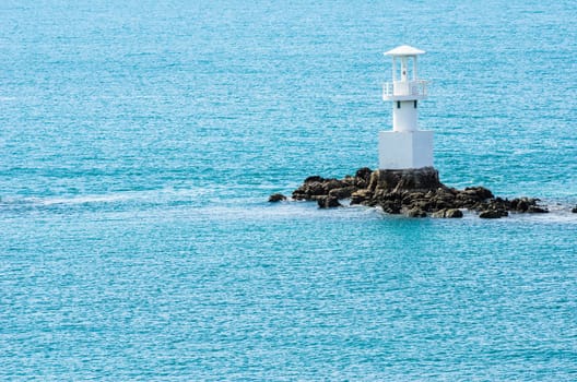 White Lighthouse on the sea and blue sky in Thailand