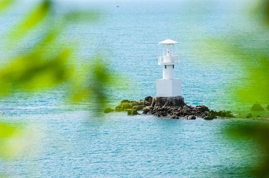 White Lighthouse on the sea and blue sky in Thailand