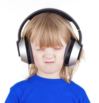 boy with long blond hair listening to music in headphones - isolated on white