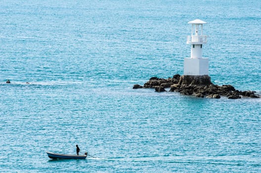 White Lighthouse on the sea and blue sky in Thailand