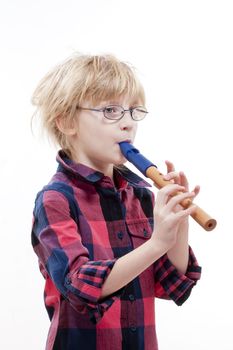 boy with blond hair and glasses playing flute - isolated on white