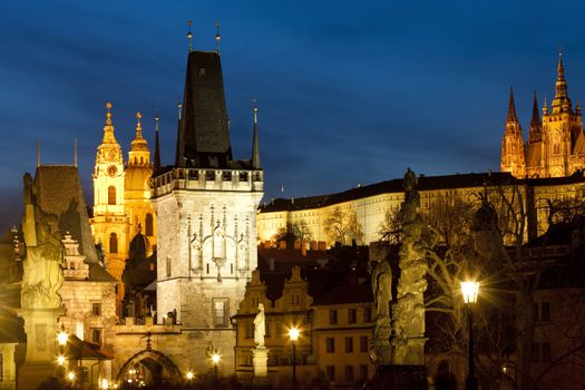 czech republic prague - charles bridge tower and st. nicolau church at dusk