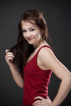 portrait of a teenage girl with brown hair against gray background