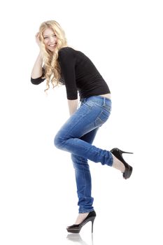 young woman with blond hair in jeans and black top - isolated on white