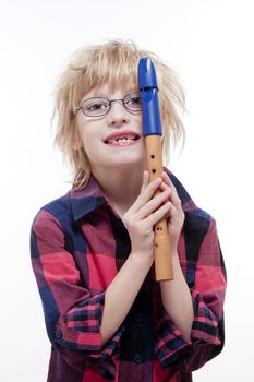 boy with missing milk teeth and glasses holding his flute - isolated on white