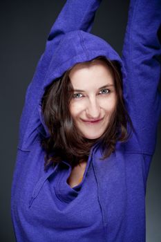 portrait of beautiful woman with brown hair smiling - gray background