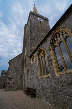 The wall of an old church, with windows and spire