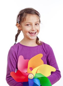 portrait of a little girl with braids holding a pinwheel - isolated on white