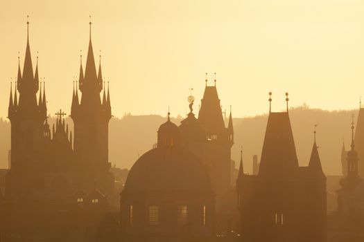 czech republic, prague - spires of the old town and tyn church on misty morning