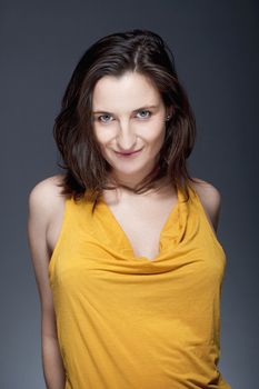 portrait of beautiful woman with brown hair looking - gray background