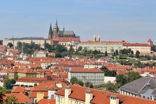 Photo shows details of Prague red roofs and old houses.