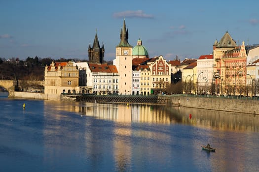 Photo shows various historical houses, Vltava river, bridges and other architectural details.