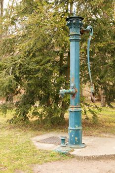 Photo shows old green water pipe.