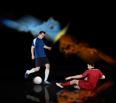 Football players tackling for the ball on black background with lights