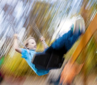 Boy on a Swing in the Playground