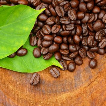 Roasted coffee beans on wood. (Arabica coffee)