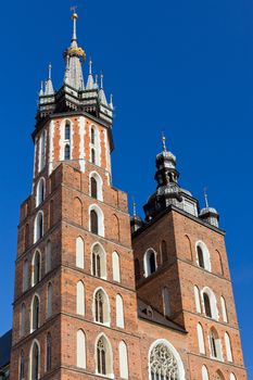 two towers of St. Mary's Basilica on main  market sguare  in cracow in poland on blue sky background