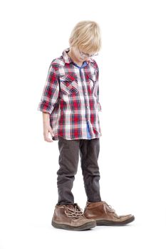 little boy wearing his father�s shoes - isolated on white