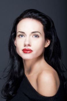 portrait of beautiful woman with dark hair and blue eyes