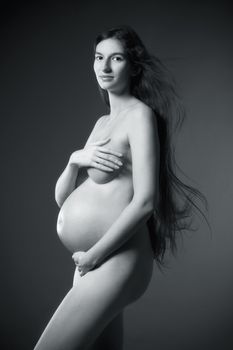 nude pregnant woman with very long brown hair