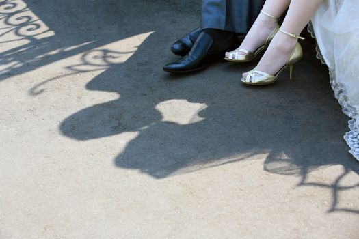 Shadow of the groom and the bride on asphalt
