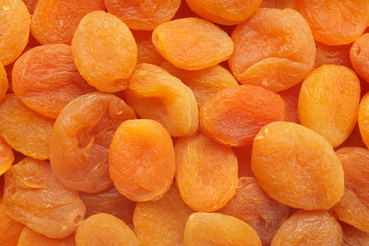 Deep orange dried apricots as an abstract background texture