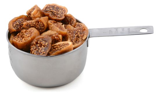 Chopped figs in an American cup measure, isolated on a white background
