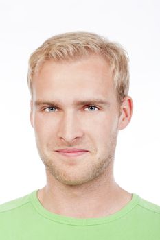 portrait of a young man with blond hair in green top smiling - isolated on white