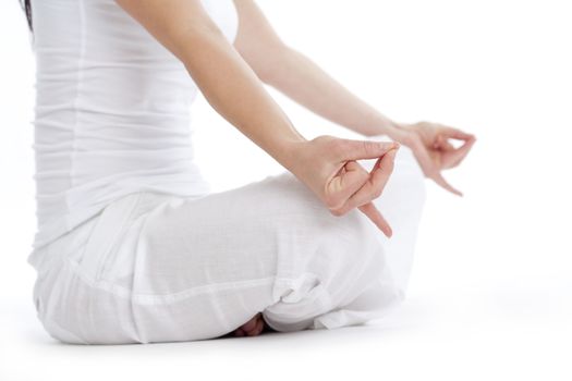 woman sitting on the floor exercising yoga - isolated on white