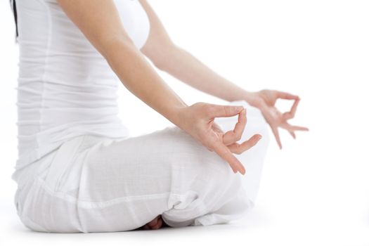 woman sitting on the floor exercising yoga - isolated on white