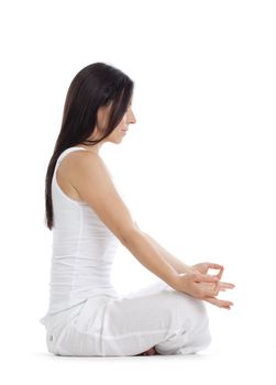 woman sitting on the floor exercising yoga - isolated on white