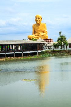 Giant statue of famous thai monk and the reflection, the statue is located in Ayutthaya Province, Thailand