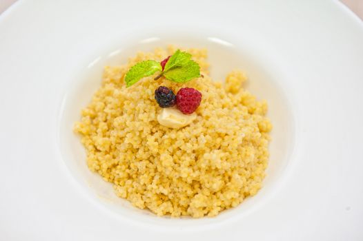 Millet porridge with berry closeup