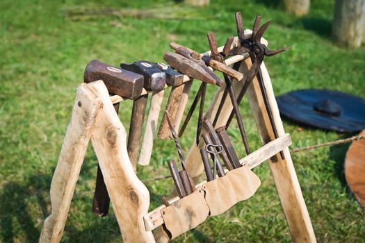 Old wooden rack with blacksmith's tool