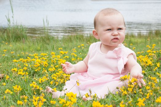 Sweet baby girl in a field of buttercups